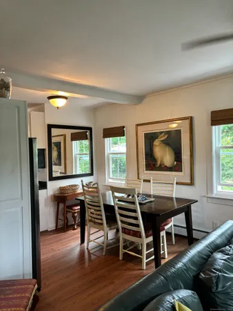 a dining room with furniture and wooden floor