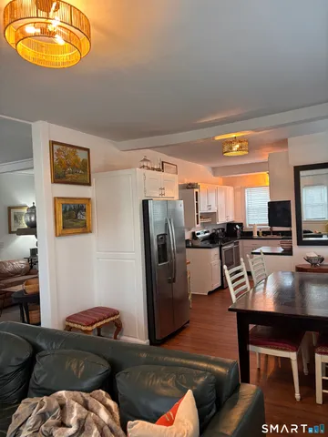 a living room with furniture a rug and a window