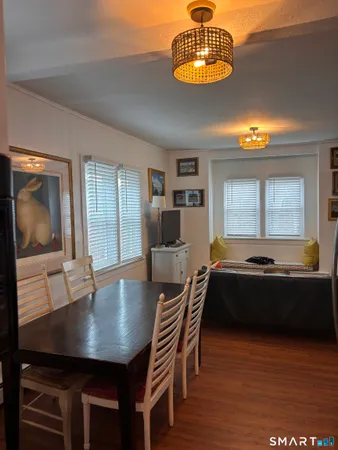 a living room with dining room and wooden floor