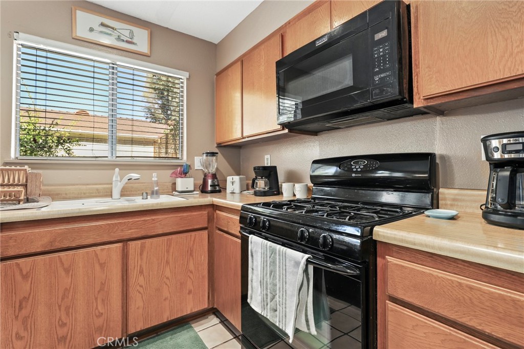 6668 Julliard Avenue, Unit D Moorpark, CA 93021 - Photo 13 of 31 a kitchen with stainless steel appliances a stove microwave and sink