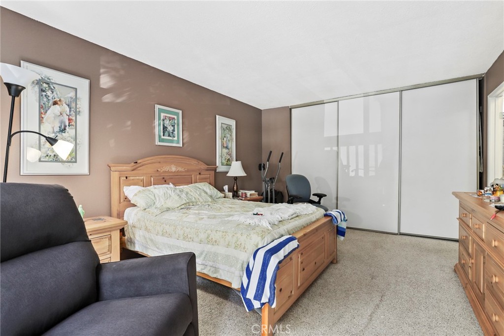 6668 Julliard Avenue, Unit D Moorpark, CA 93021 - Photo 19 of 31 a bed room with a bed and a couch