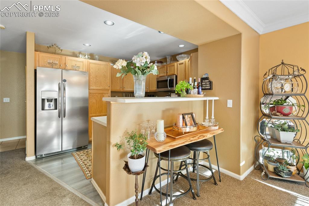 5639 Sunshade Point Colorado Springs, CO 80923 - Photo 11 of 36 a view of kitchen with dining table and chairs