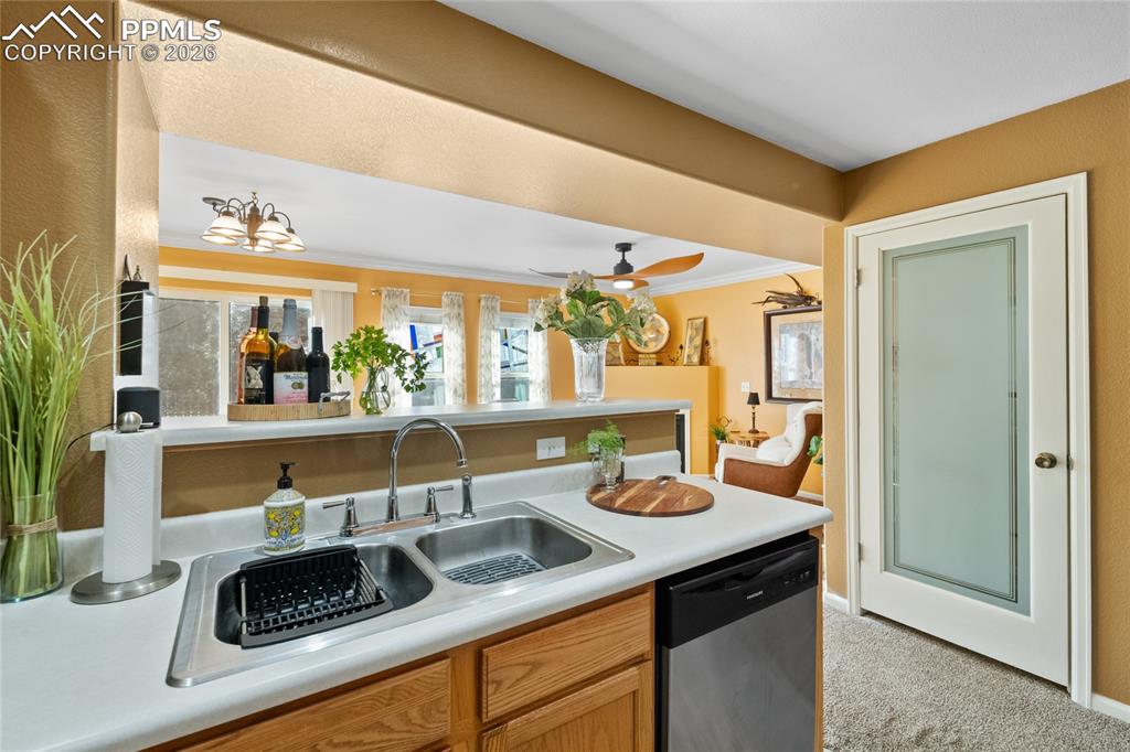 5639 Sunshade Point Colorado Springs, CO 80923 - Photo 14 of 36 a kitchen with a sink and a stove top oven