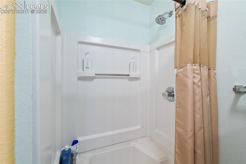 5639 Sunshade Point Colorado Springs, CO 80923 - Photo 21 of 36 a bathroom with a shower and a tub