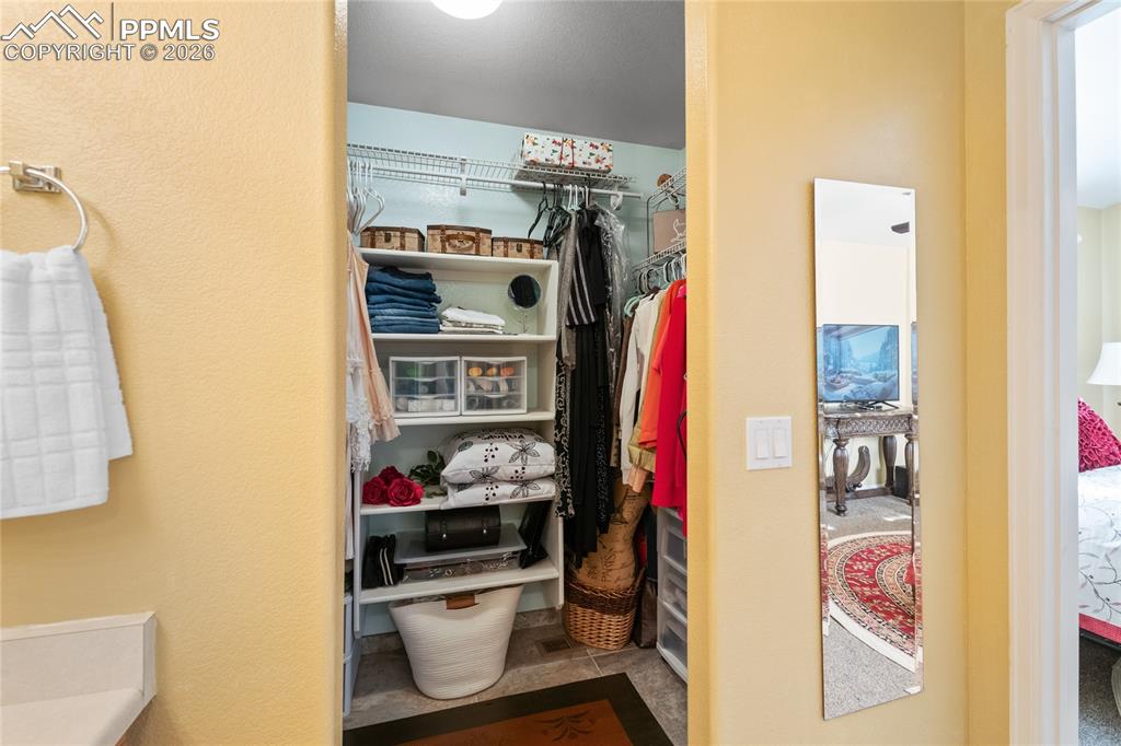 5639 Sunshade Point Colorado Springs, CO 80923 - Photo 22 of 36 a view of walk in closet with clothes and shoes