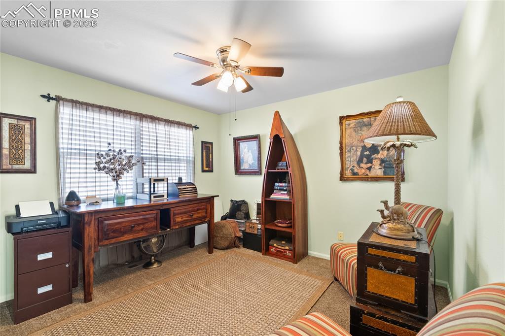 5639 Sunshade Point Colorado Springs, CO 80923 - Photo 23 of 36 a bedroom with a workspace