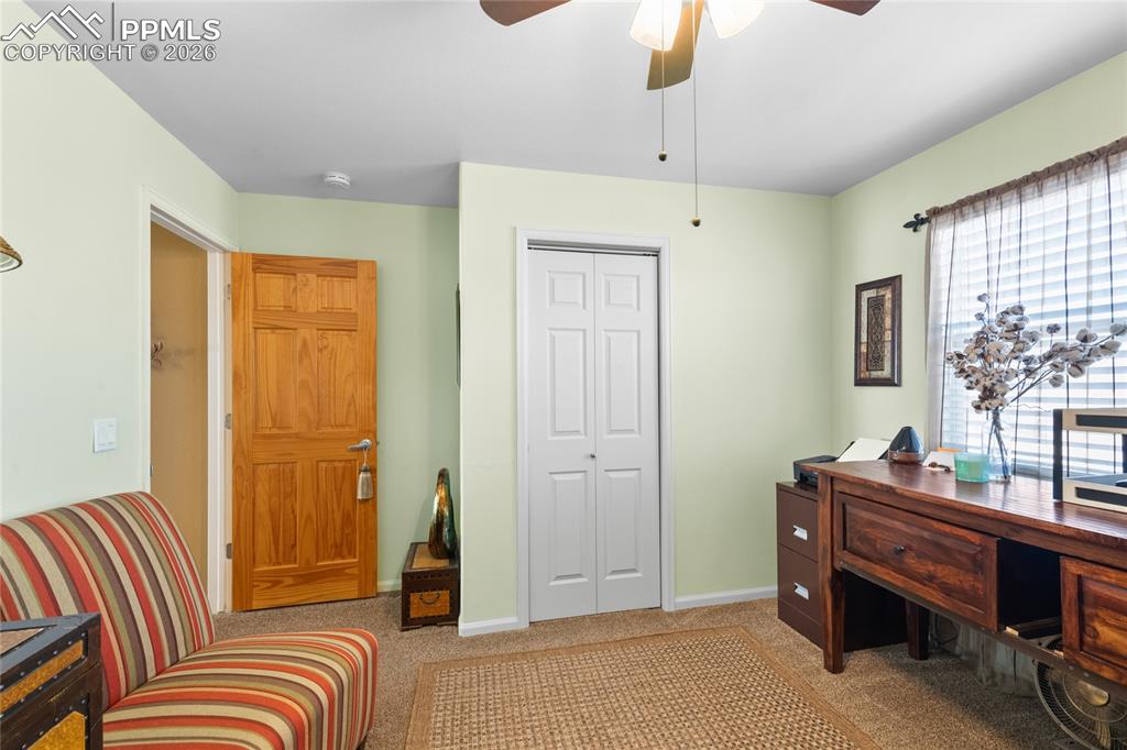 5639 Sunshade Point Colorado Springs, CO 80923 - Photo 24 of 36 a bedroom with furniture and a window