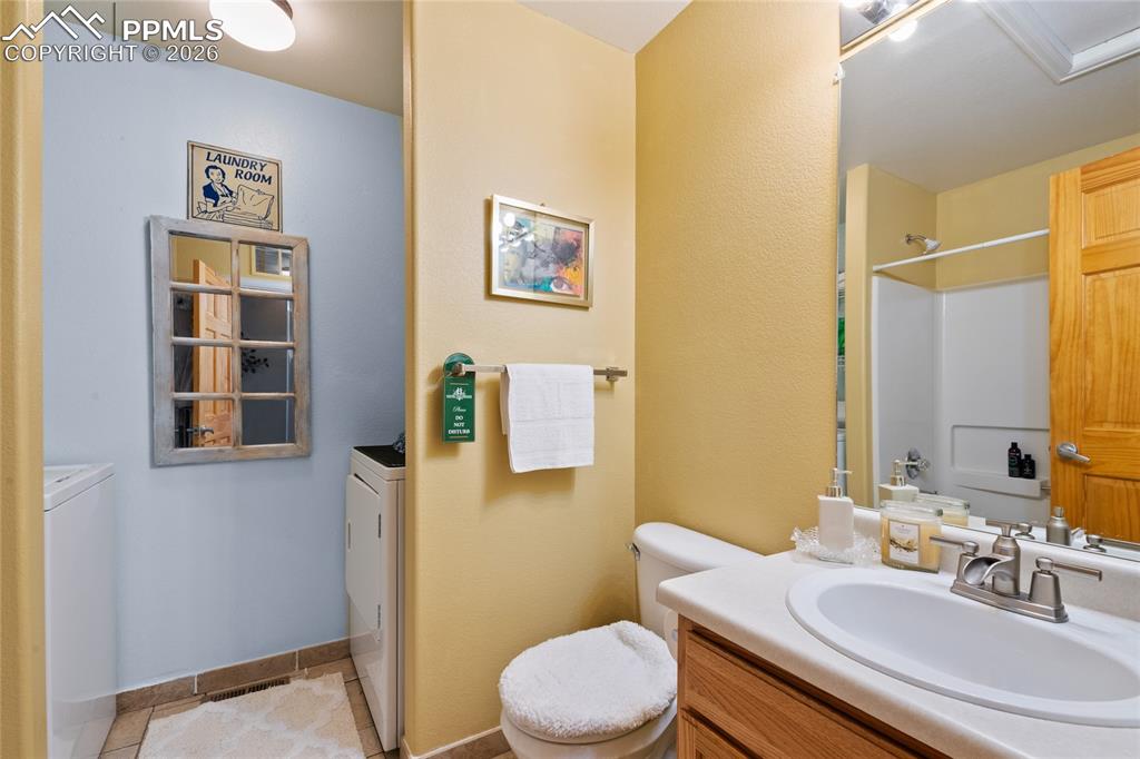 5639 Sunshade Point Colorado Springs, CO 80923 - Photo 25 of 36 a bathroom with a sink a toilet and shower