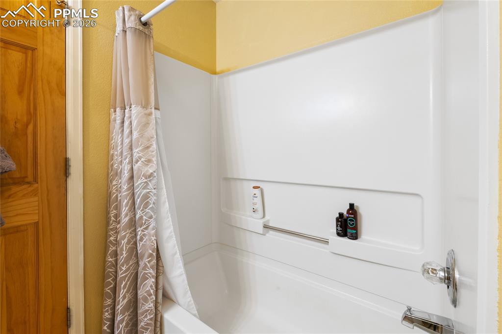5639 Sunshade Point Colorado Springs, CO 80923 - Photo 26 of 36 a bathroom with a bathtub and shower