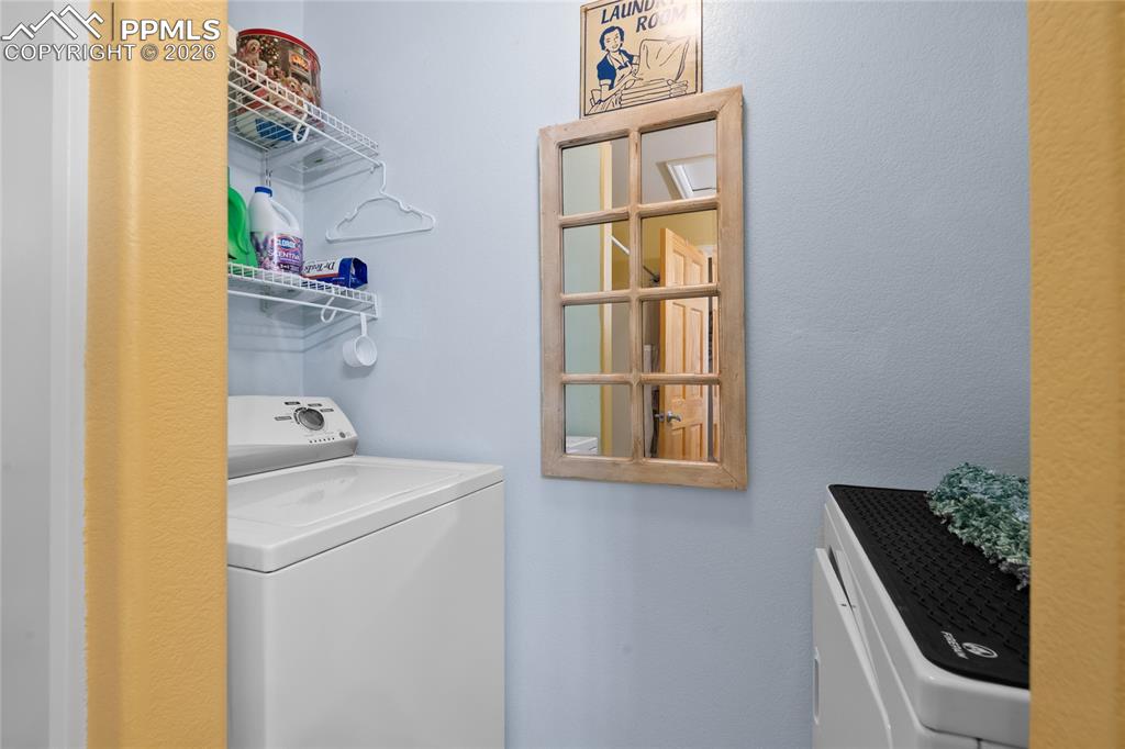 5639 Sunshade Point Colorado Springs, CO 80923 - Photo 27 of 36 a utility room with dryer and washer