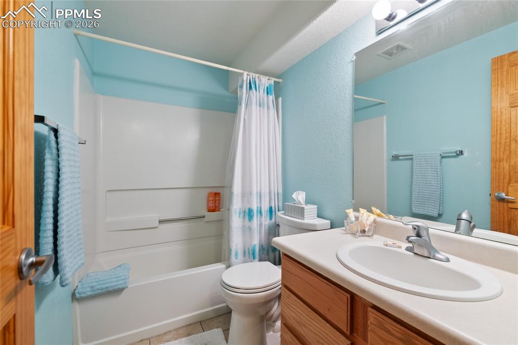 5639 Sunshade Point Colorado Springs, CO 80923 - Photo 34 of 36 a bathroom with a sink toilet and shower