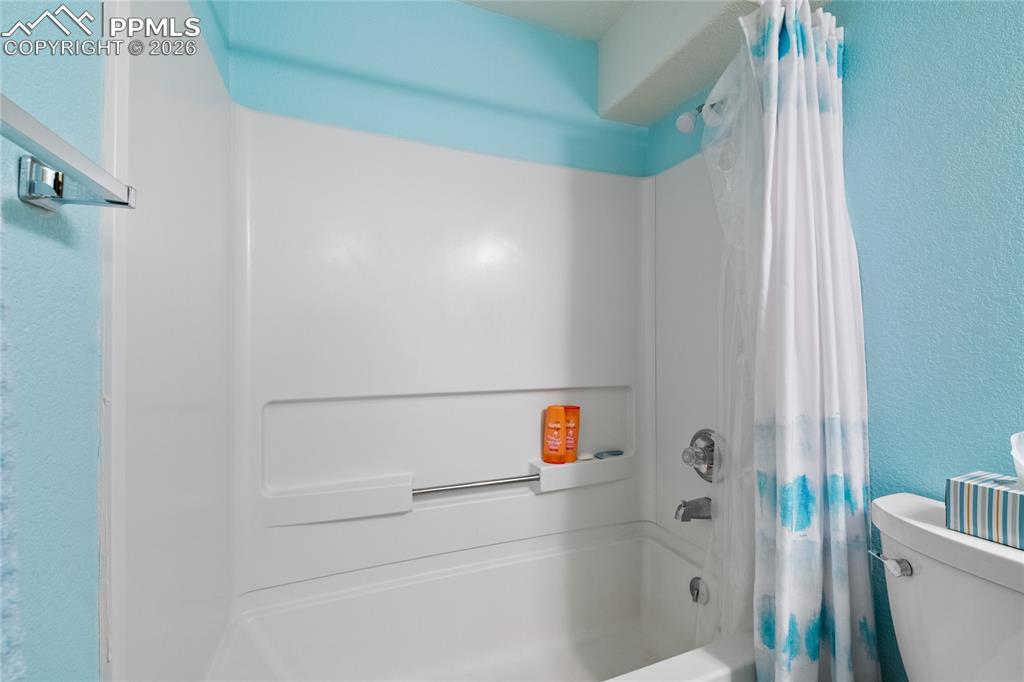 5639 Sunshade Point Colorado Springs, CO 80923 - Photo 35 of 36 a bathroom with a shower and toilet