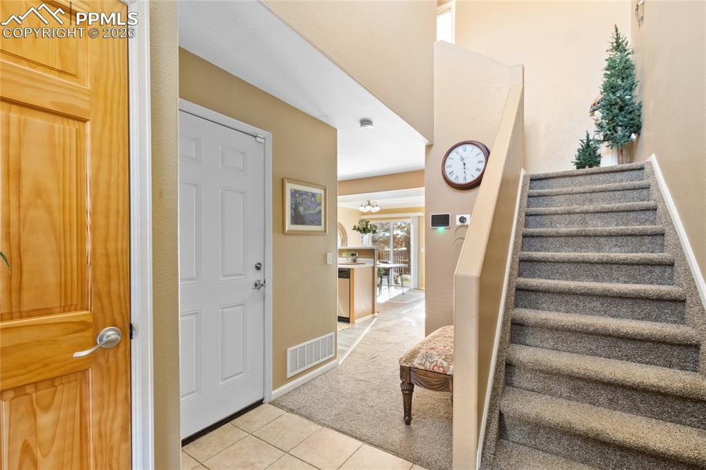 5639 Sunshade Point Colorado Springs, CO 80923 - Photo 4 of 36 a view of a hallway with front door