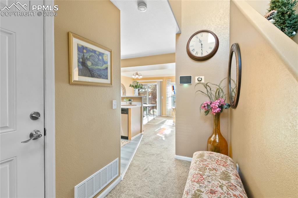 5639 Sunshade Point Colorado Springs, CO 80923 - Photo 5 of 36 a view of a hallway with furniture