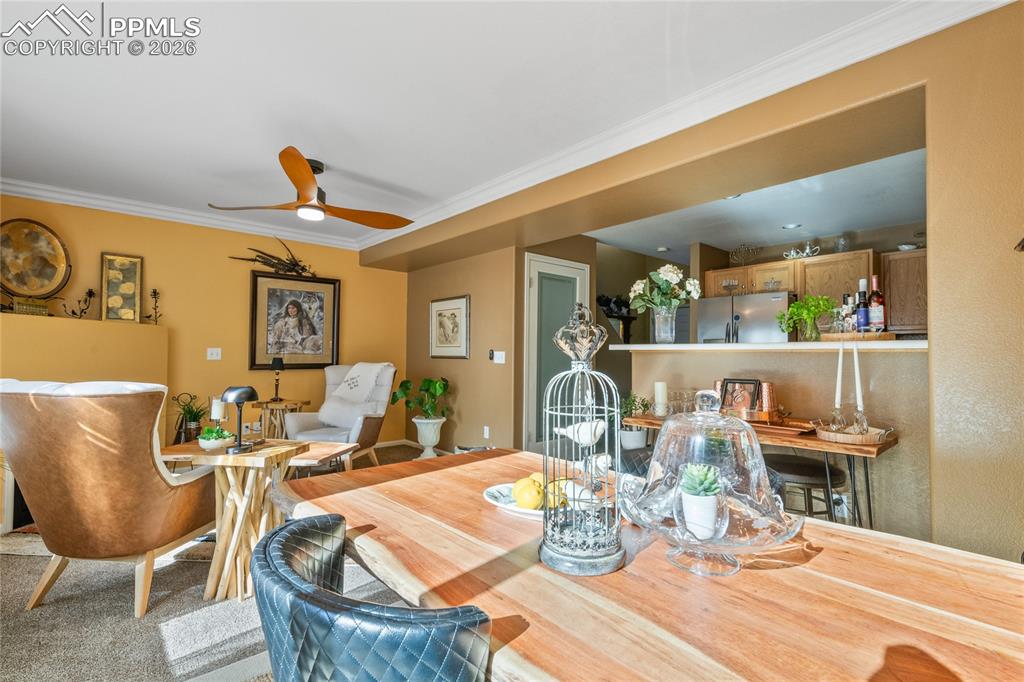 5639 Sunshade Point Colorado Springs, CO 80923 - Photo 10 of 36 a dining room with wooden floor a glass table and chairs
