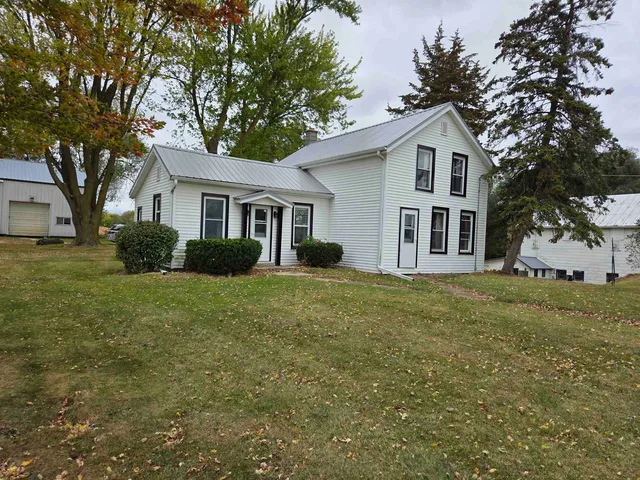 a front view of house with yard and trees