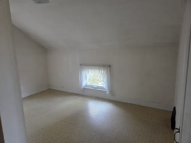 a view of empty room with floor to ceiling window