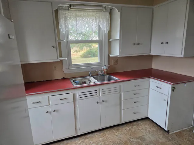 a kitchen with cabinets appliances and a sink