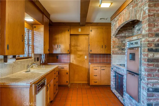 a kitchen with a sink cabinets and a window