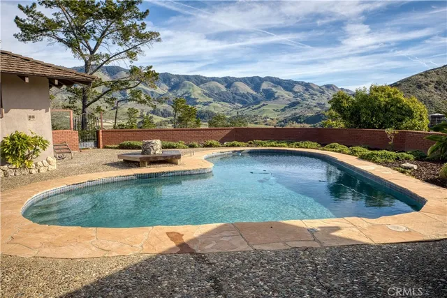 a view of a house with swimming pool and a yard