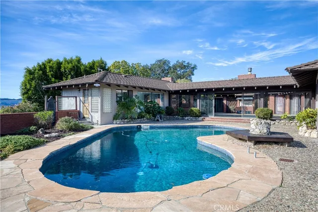 an aerial view of a house with a swimming pool