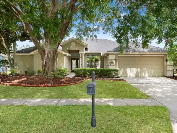 a front view of a house with yard and green space