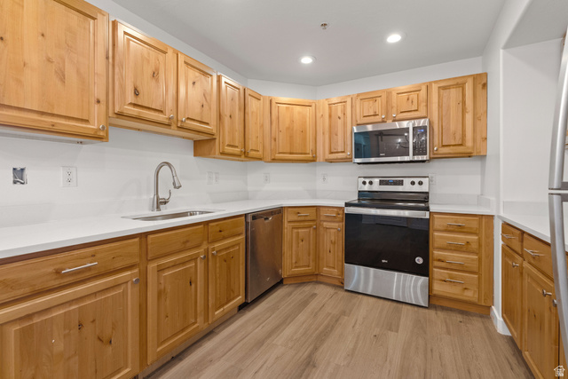 8204 North Cedar Springs Road, Unit 2 Eagle Mountain, UT 84005 - Photo 6 of 17 Kitchen with stainless steel appliances, light wood-type flooring, recessed lighting, and light stone countertops