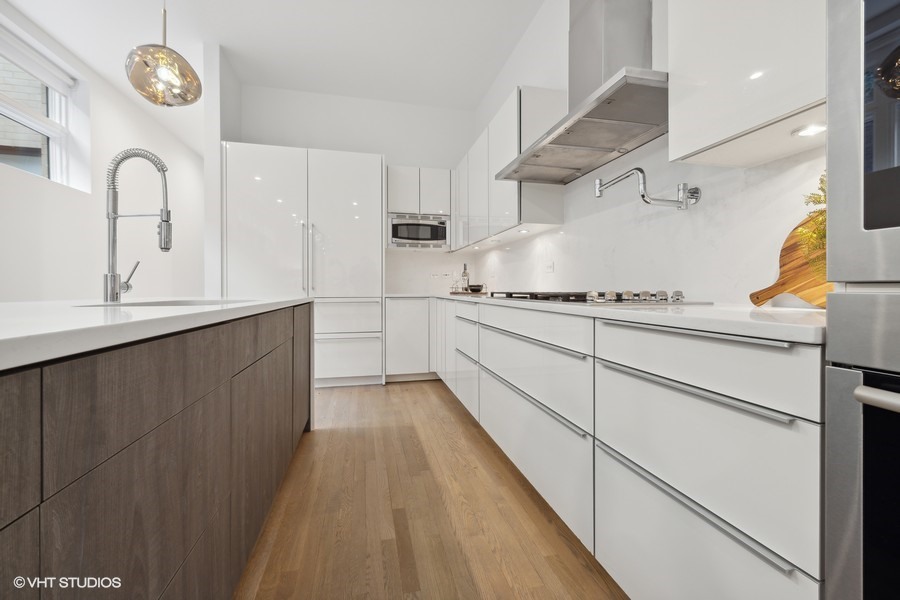 1011 North Dearborn Street Chicago, IL 60610 - Photo 12 of 33 a kitchen with stainless steel appliances granite countertop a sink and wooden cabinets