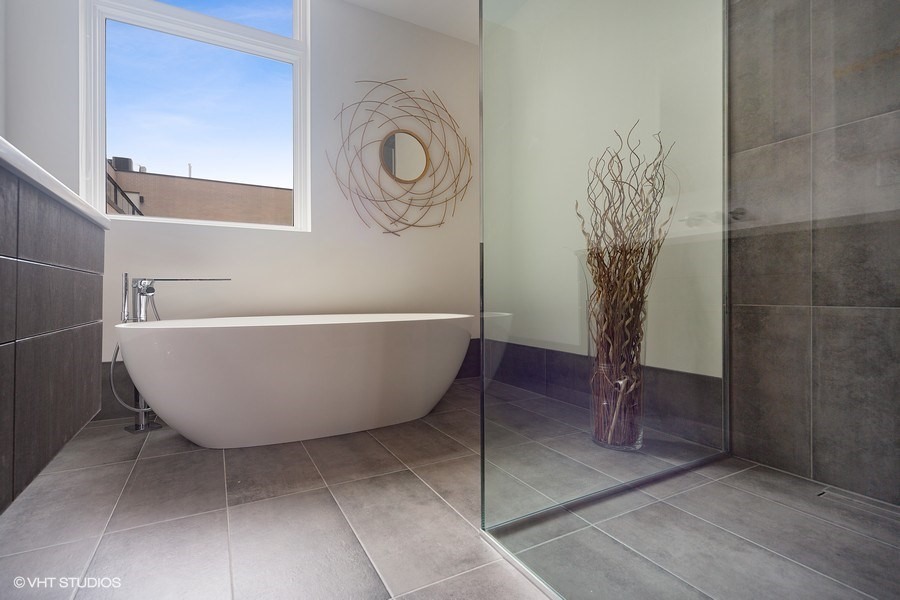 1011 North Dearborn Street Chicago, IL 60610 - Photo 19 of 33 a white tub sitting next to a shower