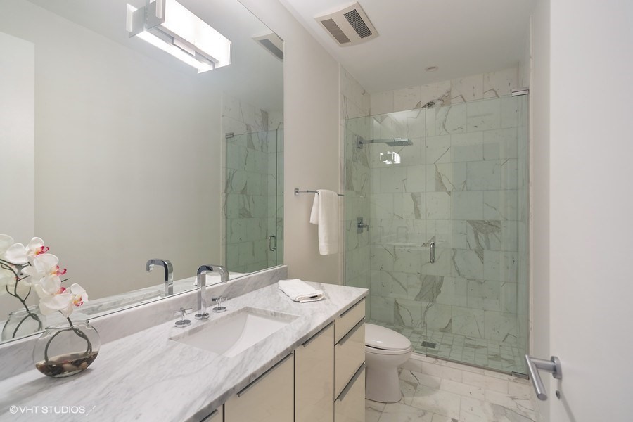 1011 North Dearborn Street Chicago, IL 60610 - Photo 23 of 33 a bathroom with a sink a toilet and shower
