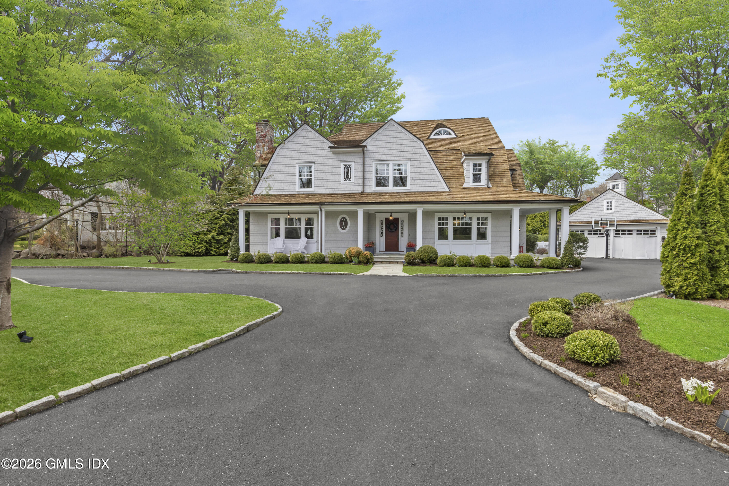 45 Willow Road Riverside, CT 06878 - Photo 31 of 35 a front view of a house with a yard and potted plants