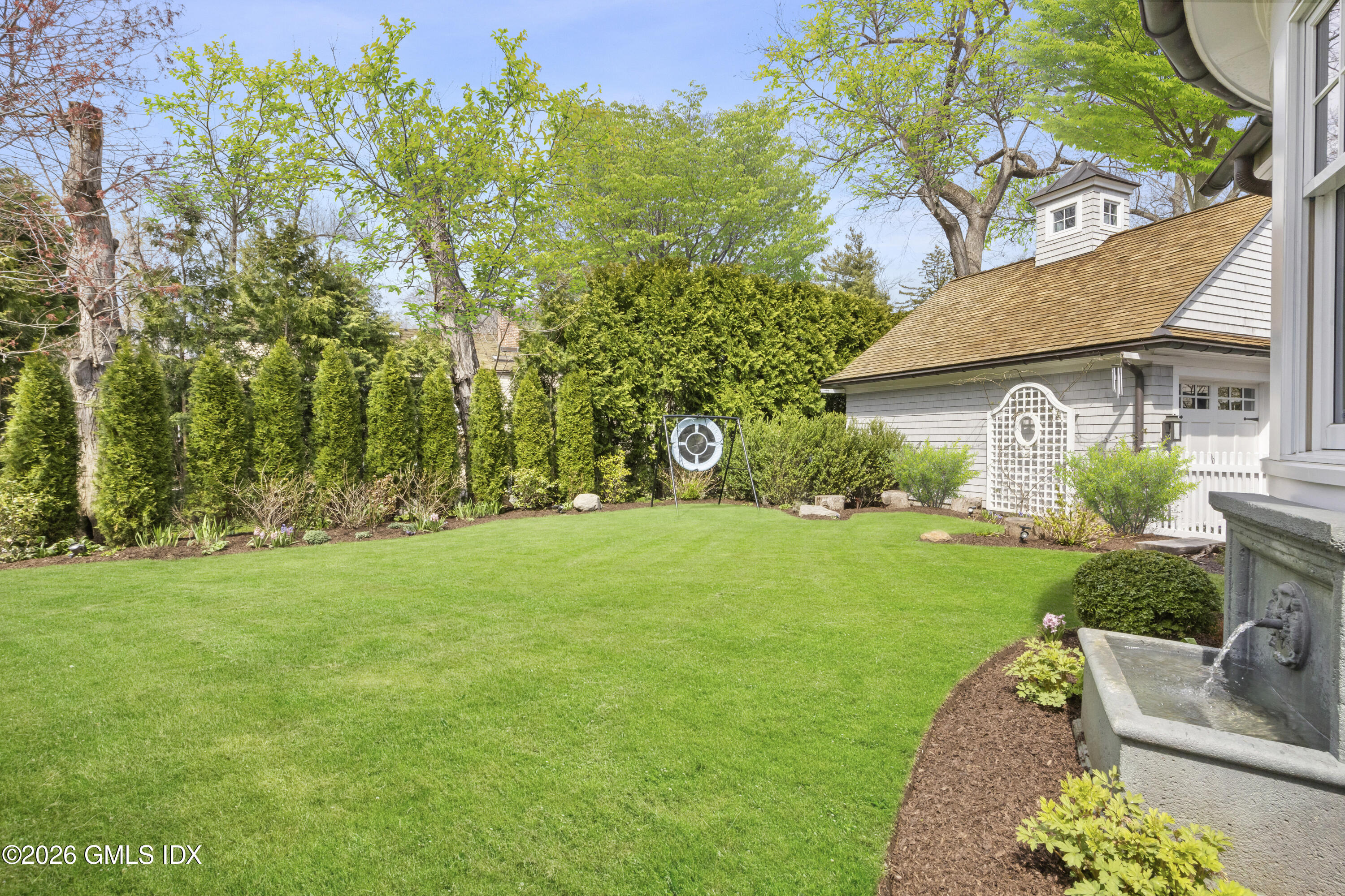 45 Willow Road Riverside, CT 06878 - Photo 32 of 35 a view of a backyard with table and chairs and potted plants