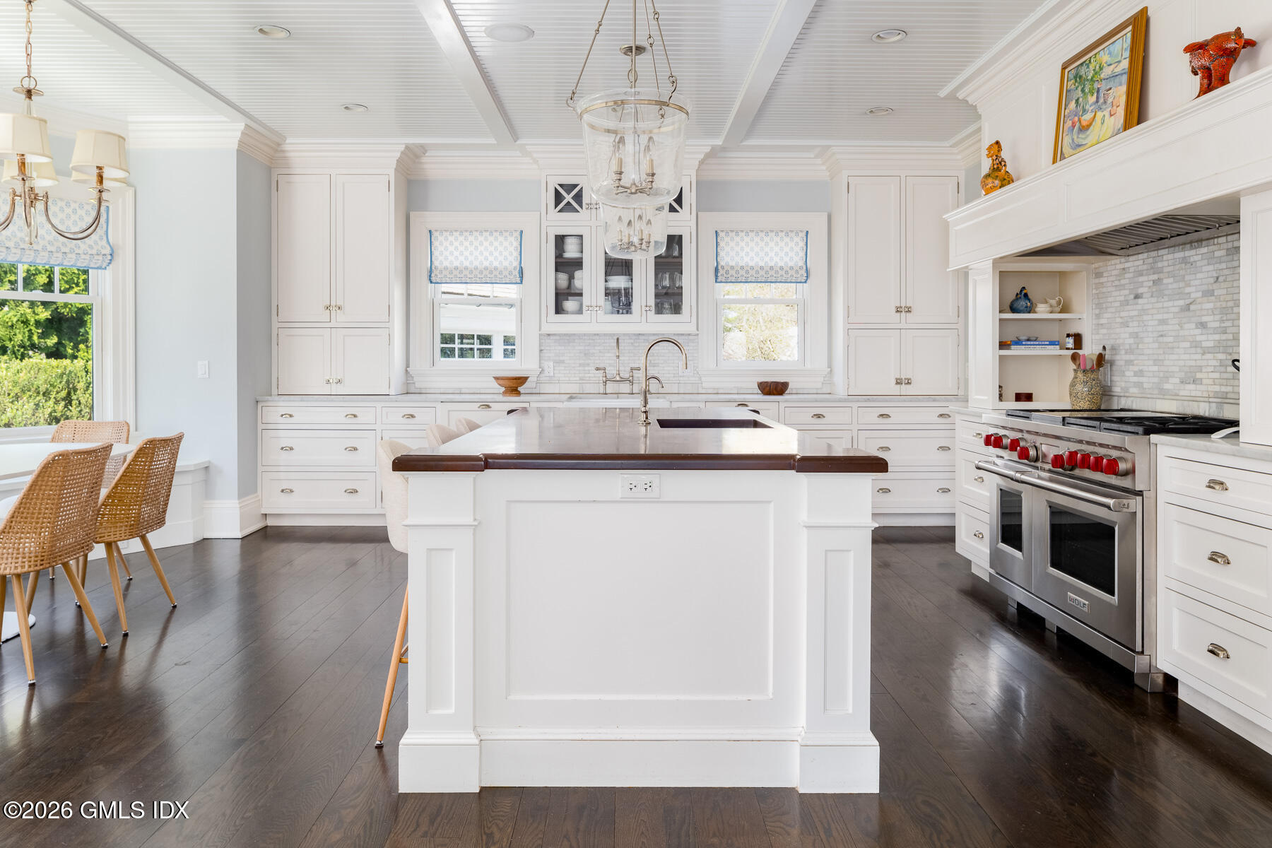 45 Willow Road Riverside, CT 06878 - Photo 9 of 35 a kitchen with stainless steel appliances a stove a sink dishwasher and white cabinets with wooden floor