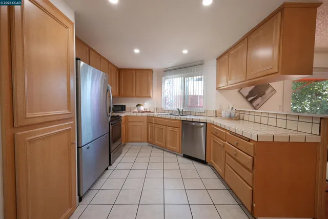 a kitchen with stainless steel appliances granite countertop a sink and cabinets