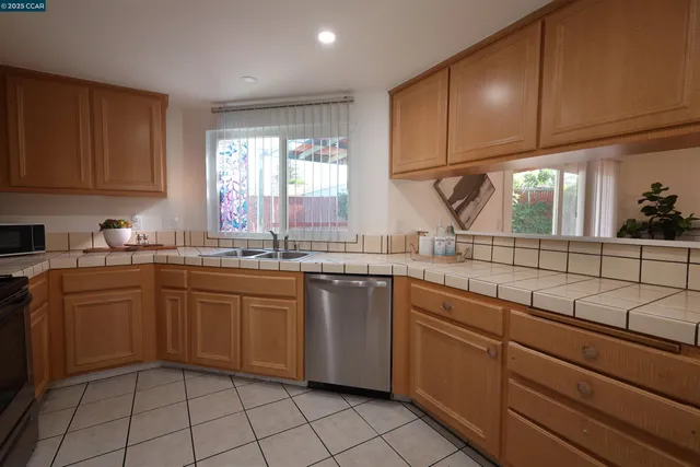 a living room with furniture fireplace and a large window