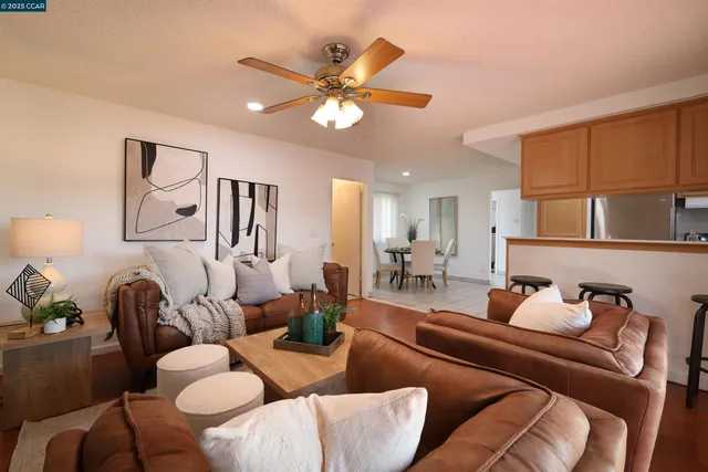 a living room with furniture and a fireplace