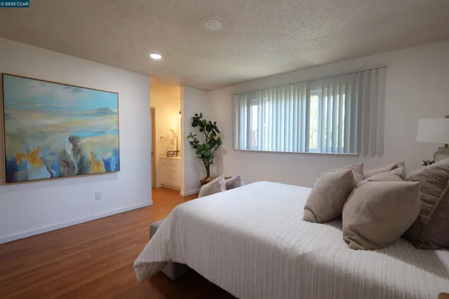 a bedroom with a bed and a potted plant