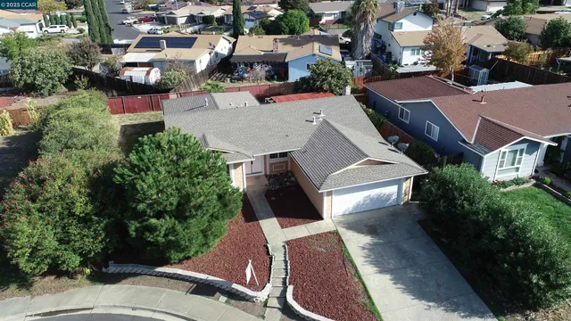 an aerial view of a house with garden space and street view