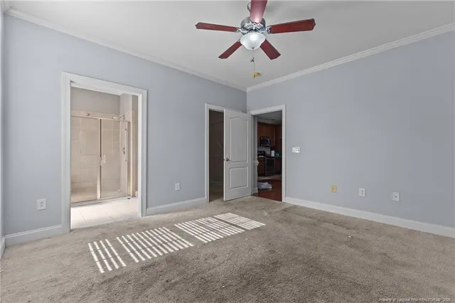 a view of a room with a ceiling fan and entryway