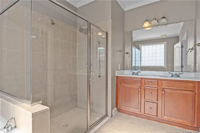 a bathroom with a granite countertop sink a mirror a vanity and a shower