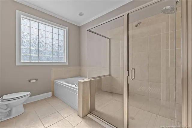 a bathroom with a toilet a sink a shower and a window