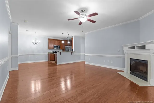 a view of a kitchen with a stove cabinets wooden floor and a fireplace