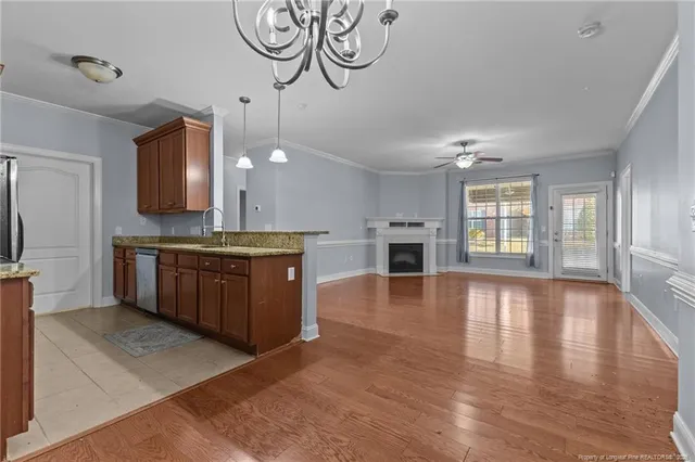 a large kitchen with kitchen island a sink stainless steel appliances and cabinets