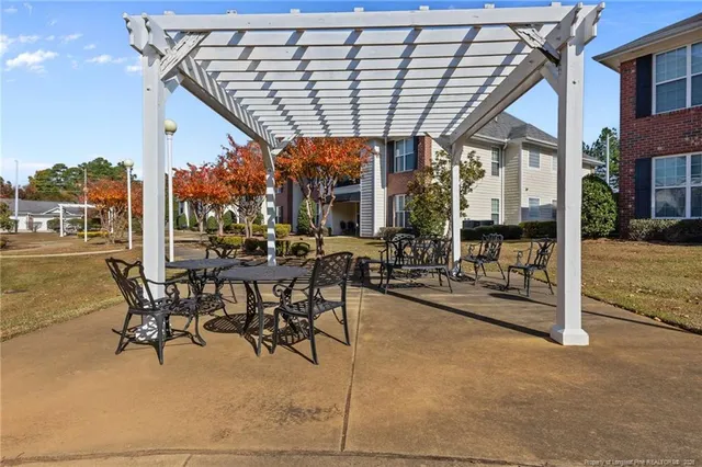 a view of a patio with table and chairs
