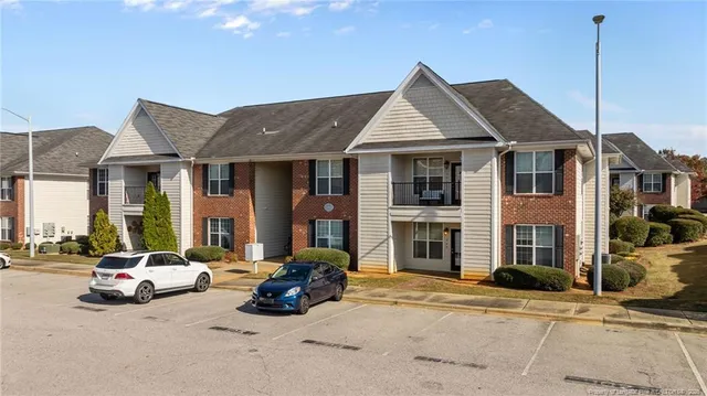 a front view of a house with parking area