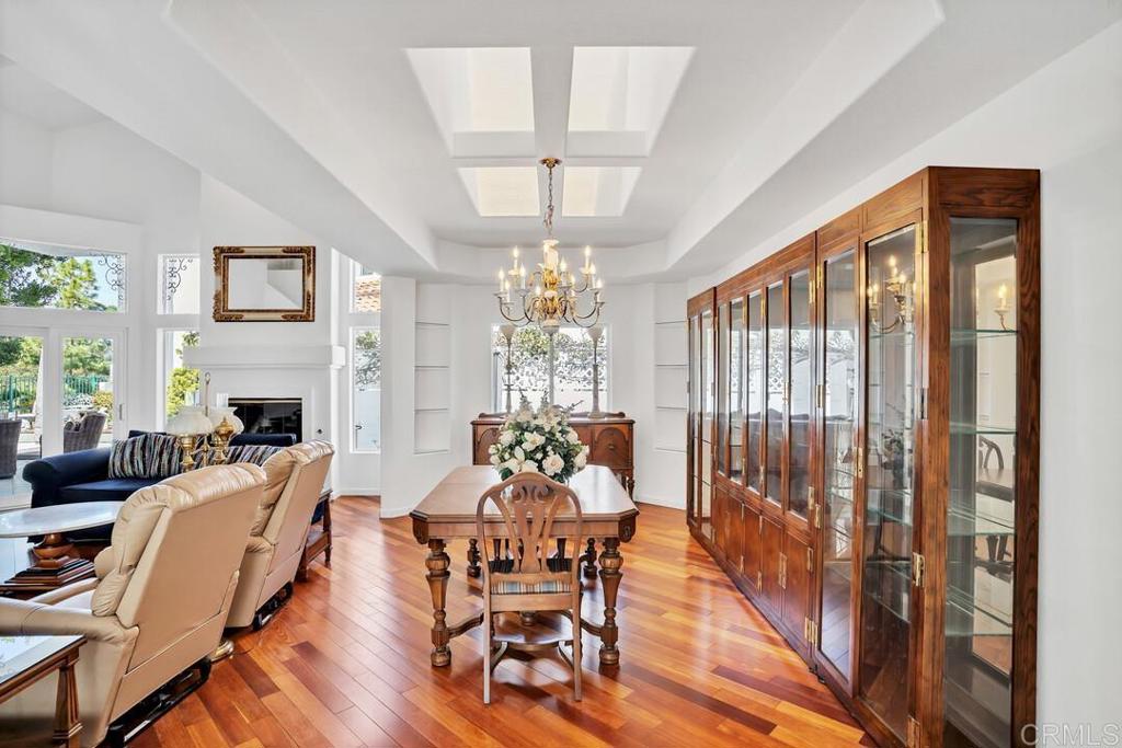 4617 Cyrus Way Oceanside, CA 92056 - Photo 14 of 63 a dining room with furniture a chandelier and wooden floor