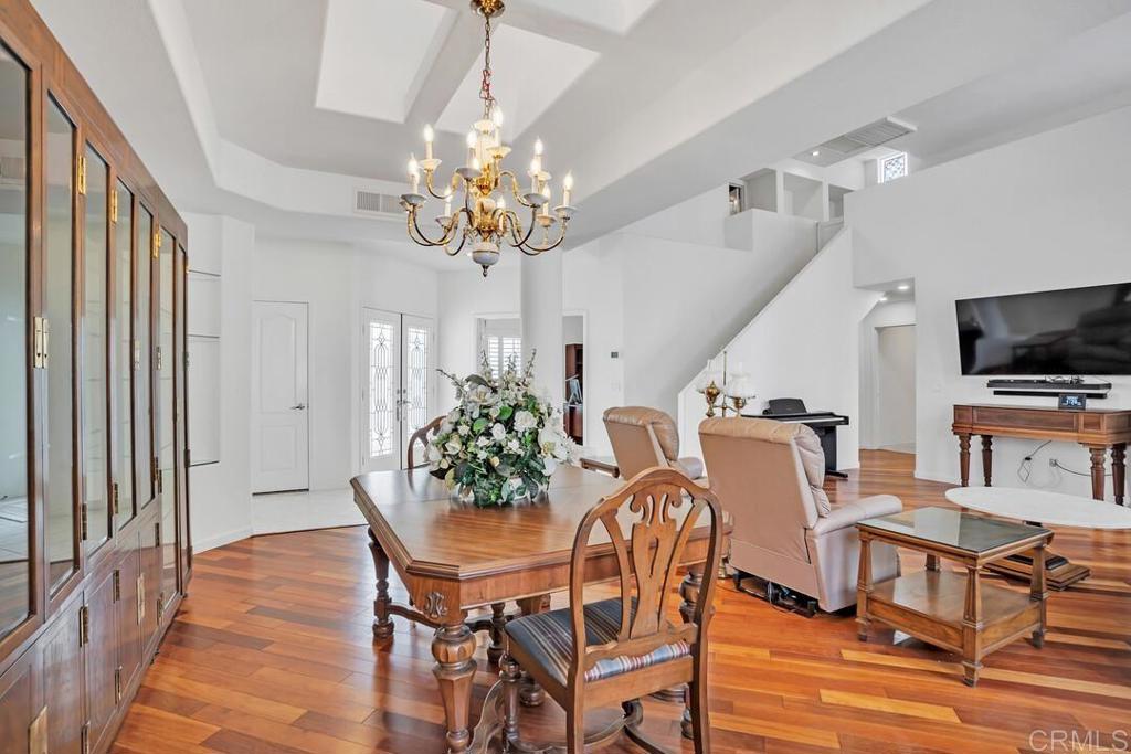 4617 Cyrus Way Oceanside, CA 92056 - Photo 15 of 63 a view of a dining room with furniture wooden floor and chandelier