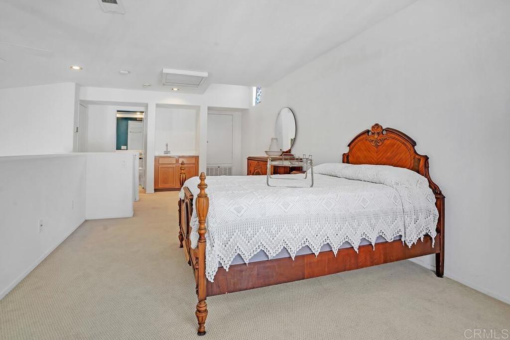 4617 Cyrus Way Oceanside, CA 92056 - Photo 23 of 63 a bed sitting in a room next to a lamp