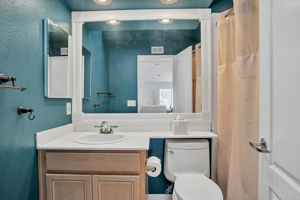 4617 Cyrus Way Oceanside, CA 92056 - Photo 25 of 63 a bathroom with a sink toilet and shower