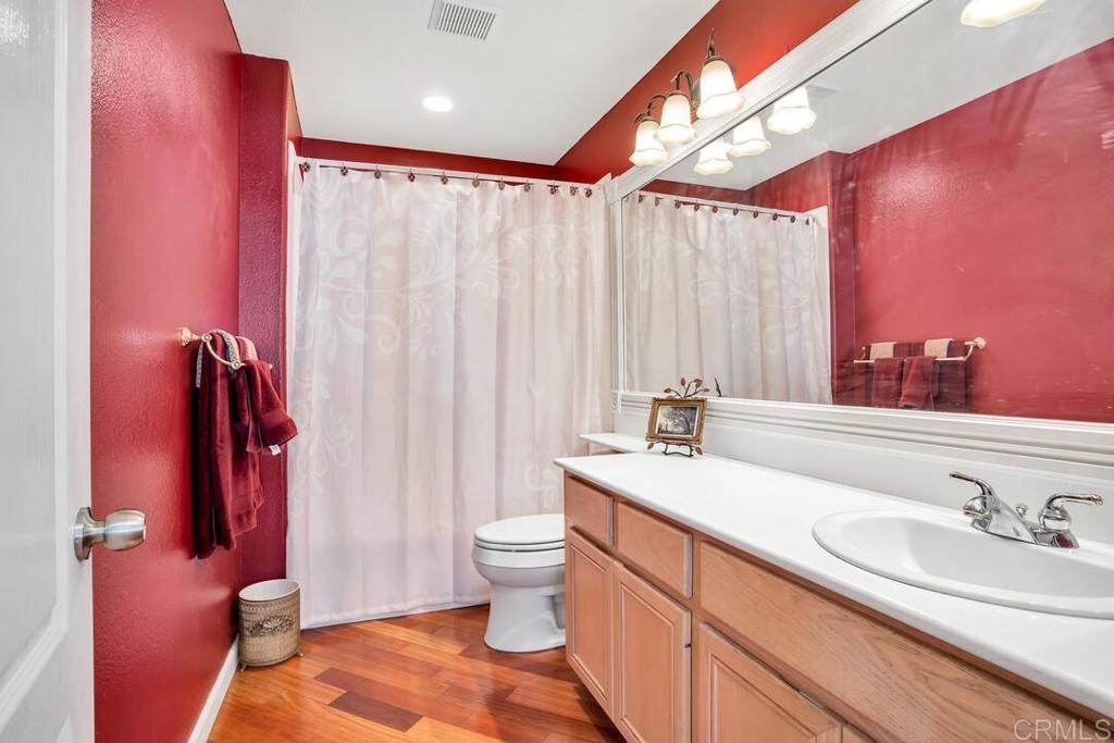 4617 Cyrus Way Oceanside, CA 92056 - Photo 30 of 63 a bathroom with a granite countertop sink and a mirror